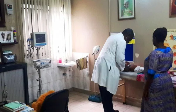 Pediatric doctor smiling with a young child patient