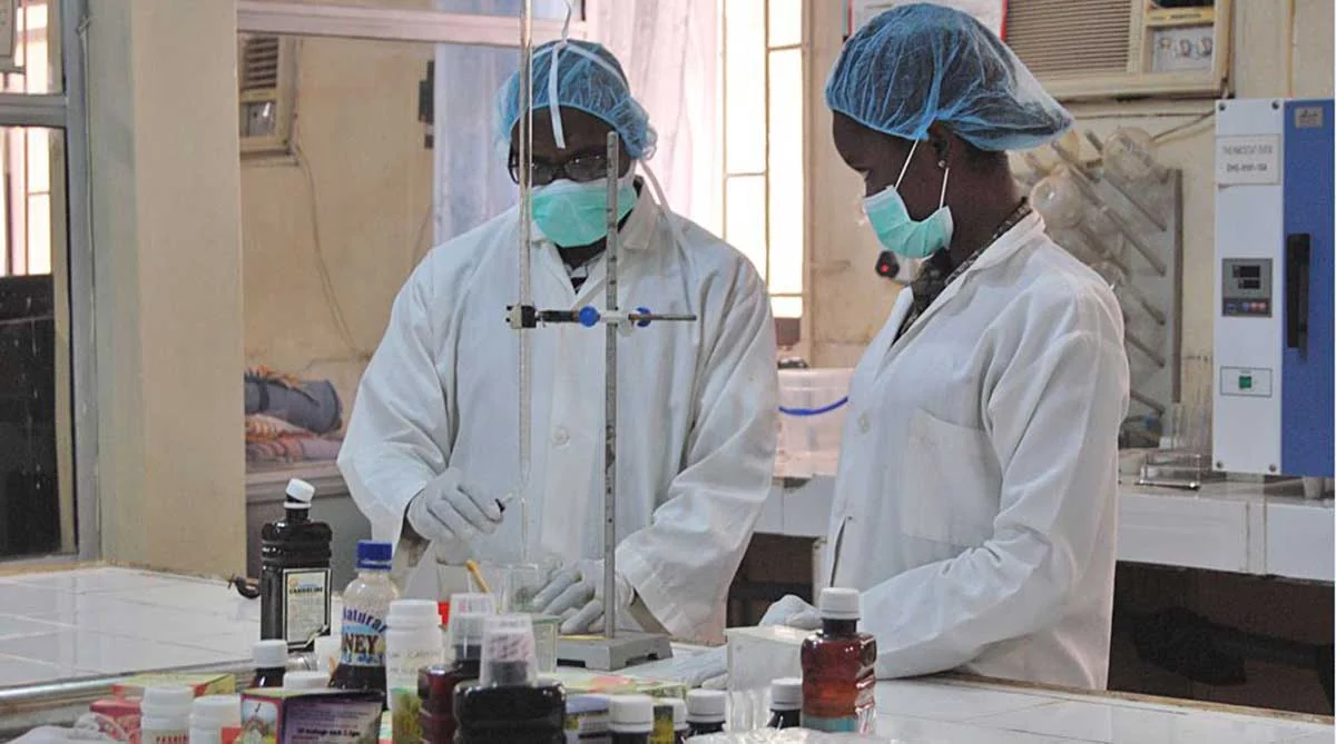 Black African laboratory technician performing medical testing at Omega Clinic